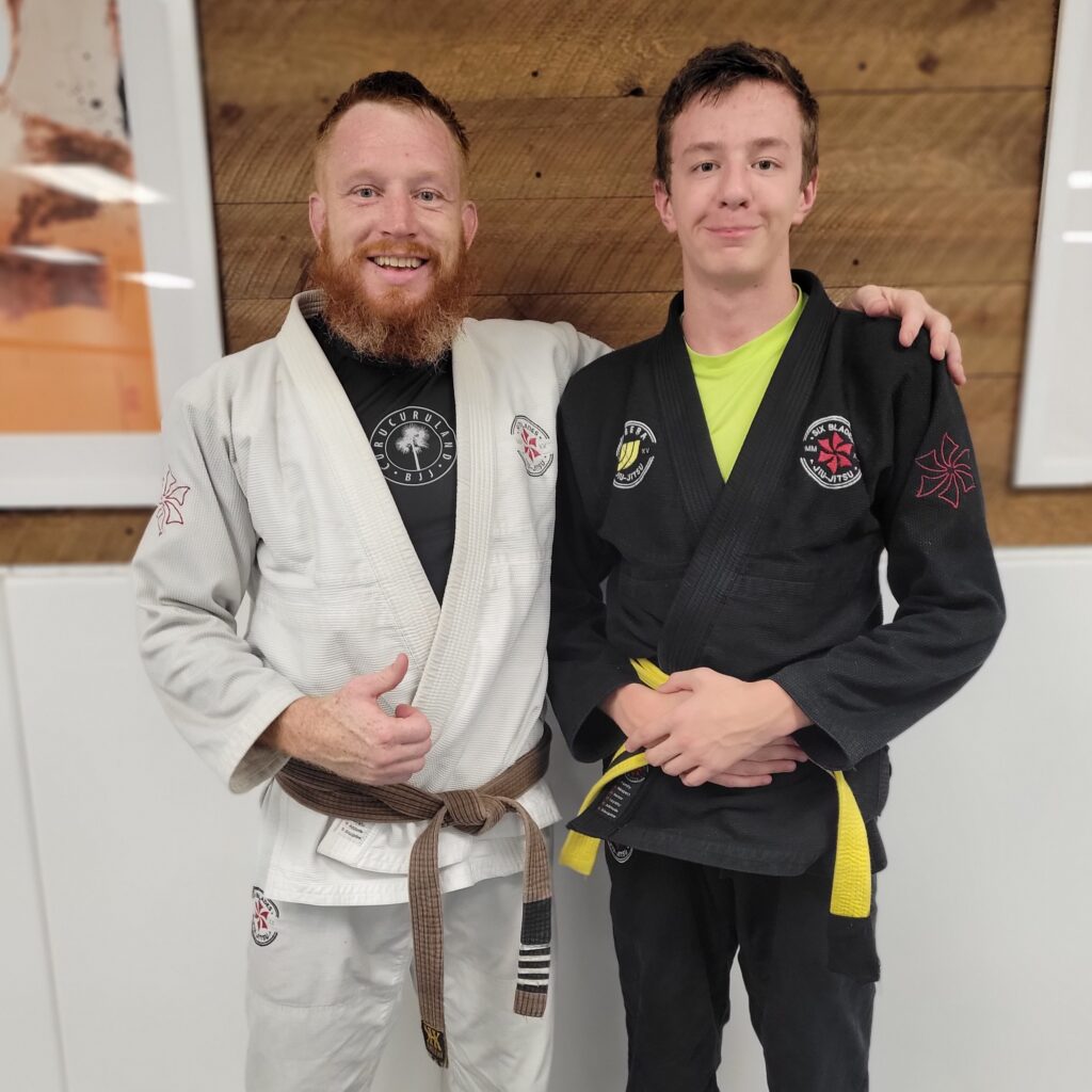 Professor Colby with Samuel preparing for competition classes